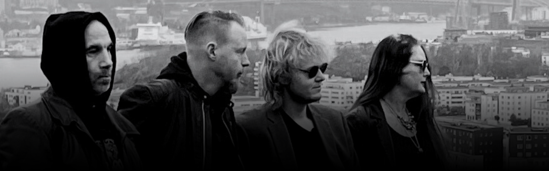 the band standing before a view of gothenburg